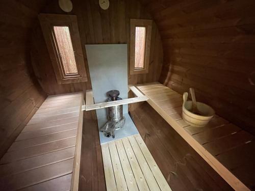 an inside view of a wooden cabin with a bucket at Black Cabin Veluwe - Wellness in het bos - Sauna in Putten
