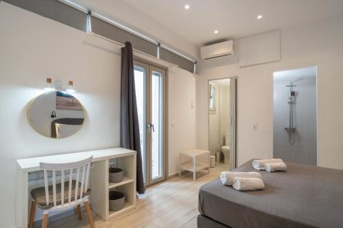 een slaapkamer met een bed, een spiegel en een bureau bij Marmara Village Home in Mármara
