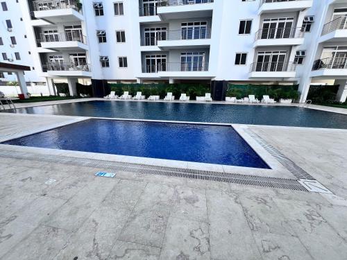 a swimming pool in front of a building at Semo's Aqua luxury 6 bedrooms Penthouse sea views in Mombasa