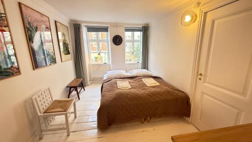 a small bedroom with a bed and a window at Latin Quater in Copenhagen