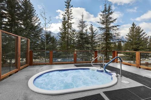 a hot tub on the deck of a house at Mountain View Escape with open hot tub, Views!! in Canmore