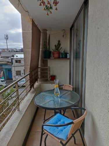 a glass table and two chairs on a balcony at Recoleta Urban Suite in Santiago
