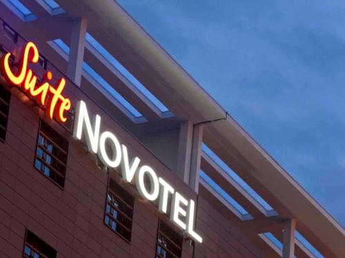 a neon sign on the side of a building at Novotel Suites Hannover in Hannover