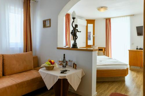a living room with a couch and a table in a room at Hotel Kalenborner Höhe in Kalenborn