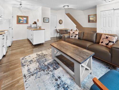 a living room with a couch and a table at Mountain Gate - Pet Friendly 2BR w Mountain Views and open hot tub in Canmore