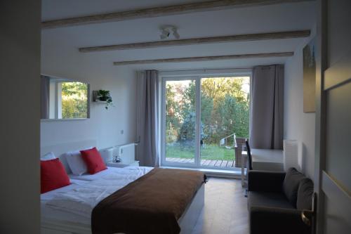 a bedroom with a bed and a large window at Apartmán Alex, Nezábudka in Tatranska Strba