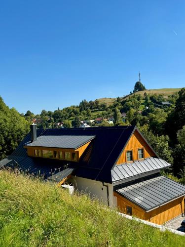 a house with solar panels on the side of it at Chata pod Jabloňou in Banská Štiavnica