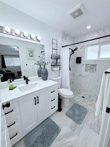 a white bathroom with a sink and a toilet at Private 1BR 1BA Suite, Kitchen, Fireplace, Parking in Simi Valley