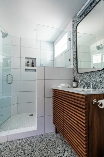 a bathroom with a shower and a sink and a mirror at Simple La Jolla Epic bungalow #7 in San Diego