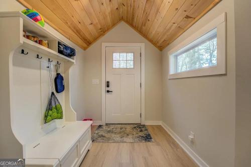 a bathroom with a white sink and a wooden ceiling at Lakefront Getaway on Jackson Lake - 3BR-2BA-Hottub in Covington
