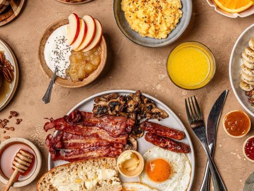 a table topped with a plate of food with breakfast foods at Mercure Hotel Erfurt Altstadt in Erfurt
