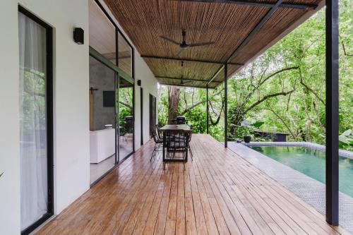 an outdoor deck with a table and chairs next to a pool at Casa con piscina privada a 700 m de Playa de Santa Teresa in Santa Teresa Beach