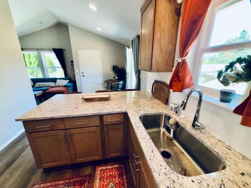 a kitchen with a sink and a counter top at Colorful Comfort 3 Bedroom Home with Fenced yard in Vancouver