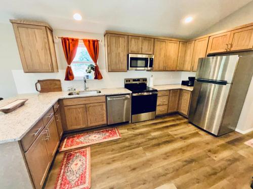 a kitchen with wooden cabinets and stainless steel appliances at Colorful Comfort 3 Bedroom Home with Fenced yard in Vancouver