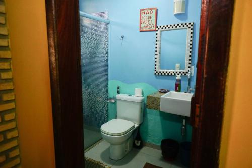 a bathroom with a toilet and a sink and a mirror at Barra Quintal - Studio 1 in Barra Grande