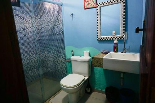 a bathroom with a toilet and a sink and a mirror at Barra Quintal - Studio 1 in Barra Grande