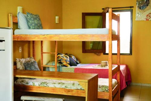 two bunk beds in a room with a bed at Barra Quintal - Studio 1 in Barra Grande