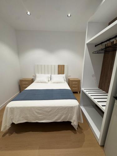 a bedroom with a large bed and a staircase at CAROLINA CENTRO SUITEs in Monesterio