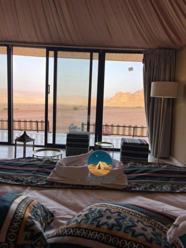 a bedroom with two beds with a view of the desert at Giulia Rum Luxury Camp in Wadi Rum