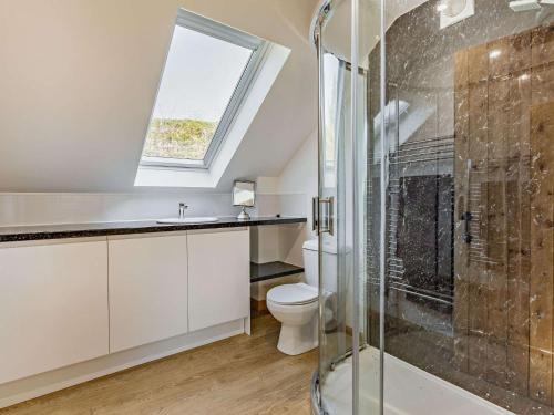 a bathroom with a toilet and a glass shower at 1 Bed in Launceston 86674 in North Petherwin