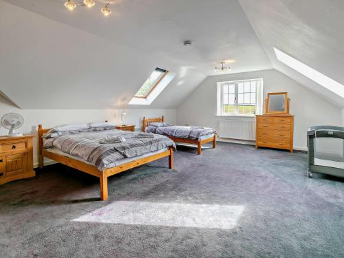 a bedroom with two beds and a tv in it at 5 Bed in Newquay 46489 in Truro