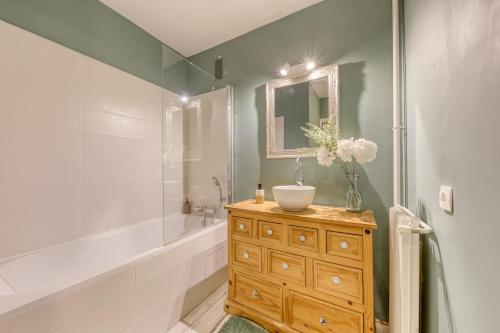 a bathroom with a sink and a bath tub and a sink at Relaxation near Paris in Saint-Denis