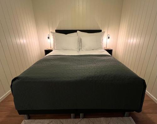 a bedroom with a large bed with two night stands at Tanabrew in Tana