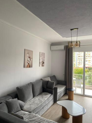 a living room with a couch and a table at Alis Apartaments in Himare