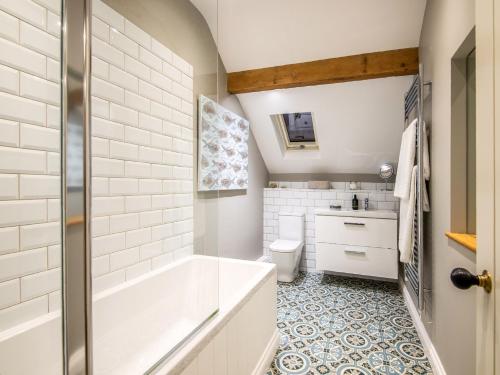 a bathroom with a tub and a toilet at 5 bed in Llangollen 77696 in Whitchurch