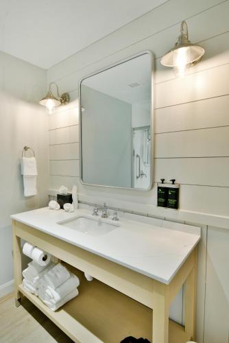 a bathroom with a sink and a mirror at Rod 'N' Reel Resort in Chesapeake Beach