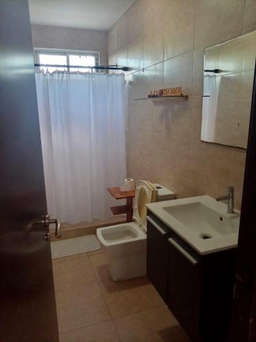 a bathroom with a toilet and a sink and a shower at Casa de 3 recámaras - Ibiza Beach House - 6153-4630 in Río Hato