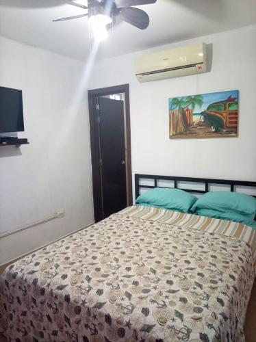 a bedroom with a bed and a ceiling fan at Casa de 3 recámaras - Ibiza Beach House - 6153-4630 in Río Hato