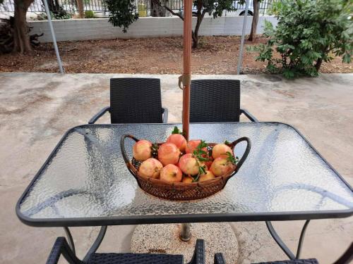 a basket of fruit on a glass table at Et In Arkadia Ego in Leonidion