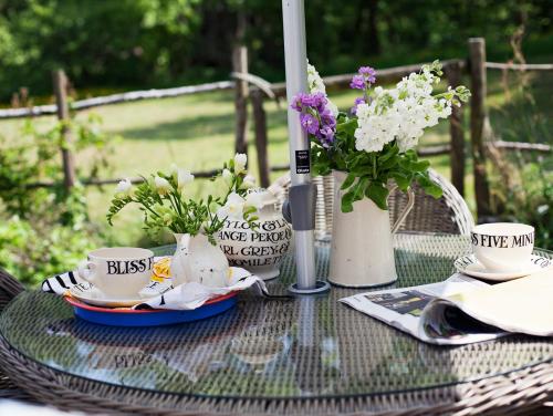 a table with plates and cups and flowers on it at 1 bed in Crickhowell 42953 in Llangattock