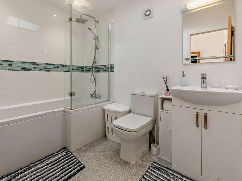 a bathroom with a toilet and a sink and a shower at 2 Bed in Portreath 82635 in Camborne