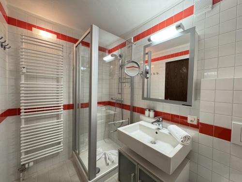 a bathroom with a sink and a shower at Casa Laret 6-12 in Laax-Murschetg