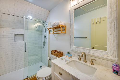 a bathroom with a sink and a shower with a mirror at Beach Days and Dtwn Charm! Cape Charles Cottage in Cape Charles