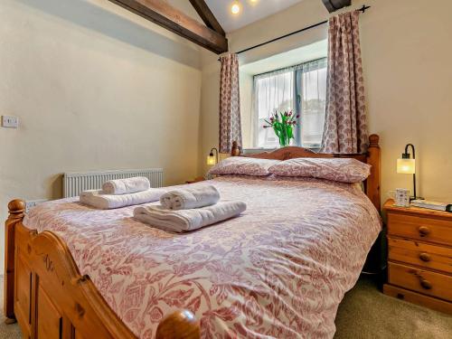 a bedroom with a large bed with two pillows on it at 1 Bed in Portreath OLDML in Camborne