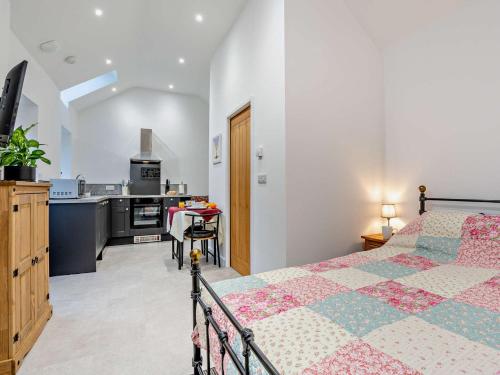a bedroom with a bed and a kitchen at 1 Bed in Pickering 96309 in Allerston