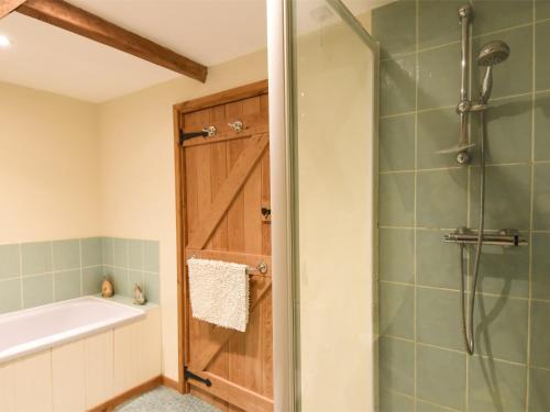 a bathroom with a shower and a tub and a shower stall at 3 Bed in Briston KT187 in Briston
