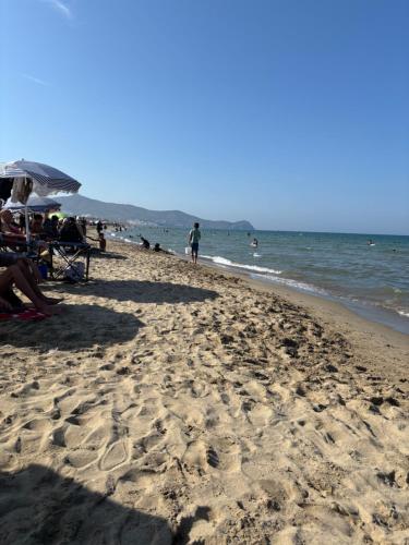 a group of people sitting on the beach at Appartement costa mar Martil in Martil