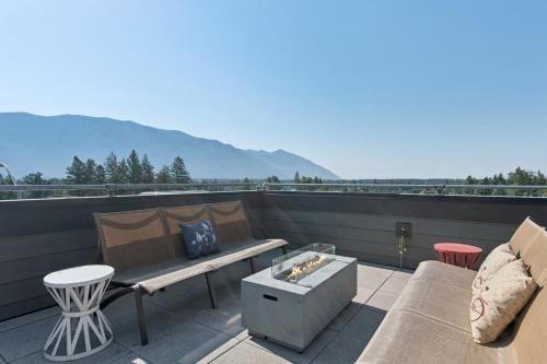 a patio with a bench and a table on a roof at Columbia Crest 301 in Columbia Falls