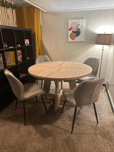 a wooden table and chairs in a room at Schillhaus Lvl 1 in Louisville