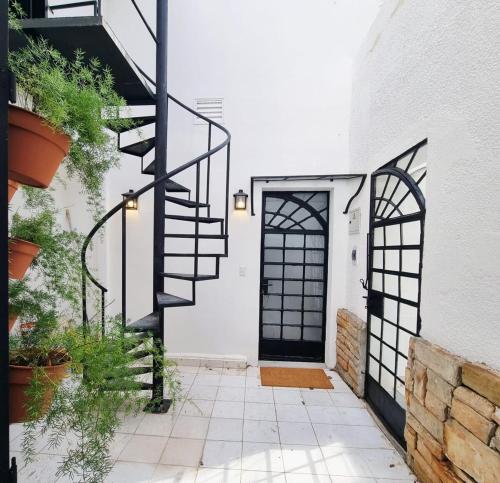 a black spiral staircase in front of a door at Casa Ernestina, Apartment 2 in Asuncion