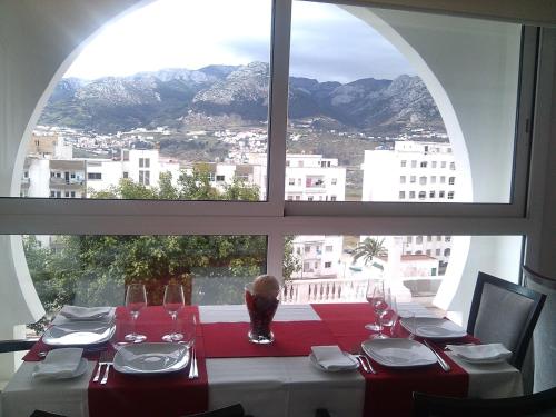 a table in a room with a large window at Al Mandari Hôtel Tétouan in Tetouan