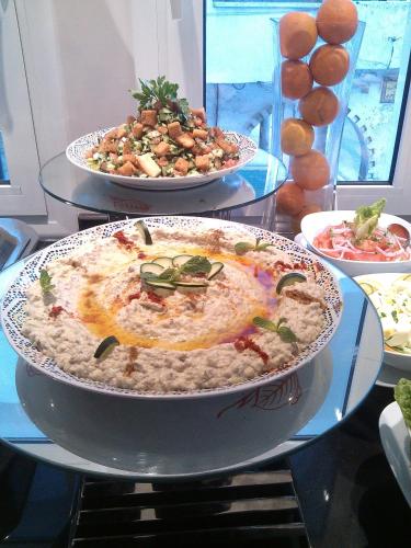 two plates of food on a glass table at Al Mandari Hôtel Tétouan in Tetouan
