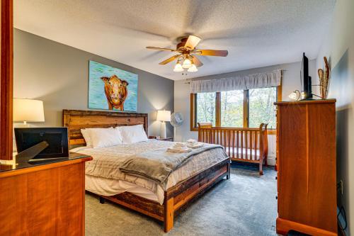 a bedroom with a bed and a ceiling fan at 6 Mi to Okemo! Family Townhome in Lakeside Resort in Tyson