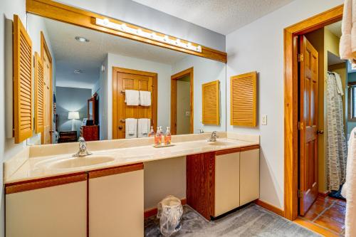 a bathroom with a sink and a mirror at 6 Mi to Okemo! Family Townhome in Lakeside Resort in Tyson