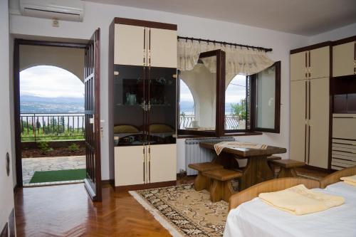 a bedroom with two beds and a table and a balcony at Villa Vera in Ičići