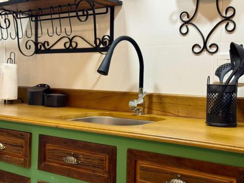 a kitchen counter with a sink and utensils at Delle Alpi 117 - Apartamento novo junto a Nasa e roda-gigante in Canela